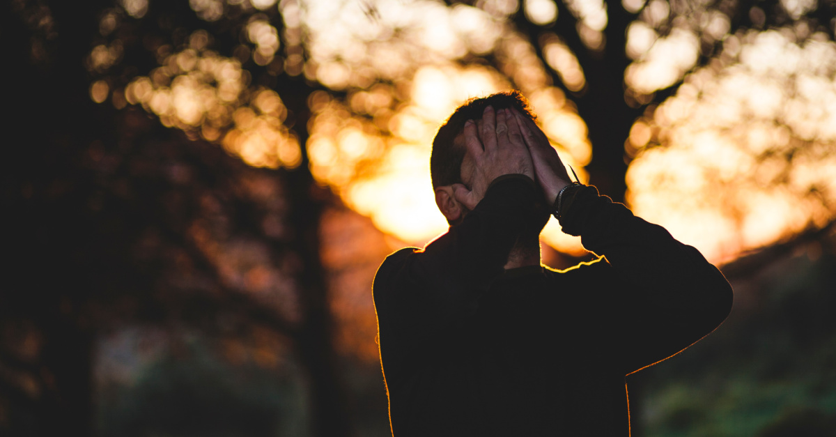 A man covering his face, Turning to God with your triumphs and your failures