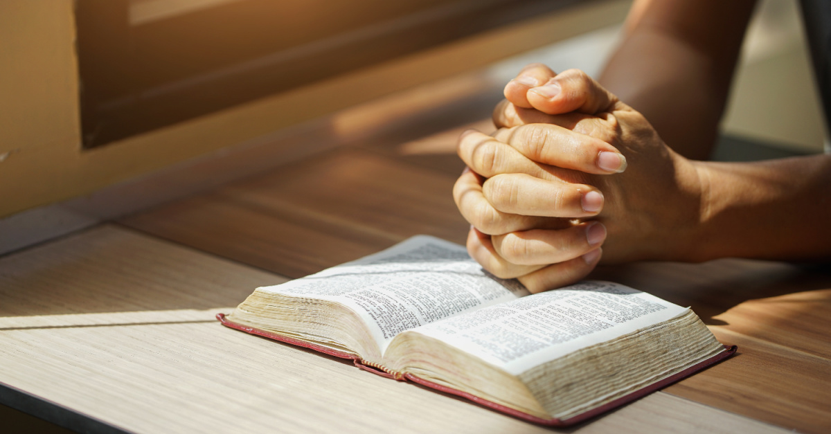 A person praying, how to pray for teachers and students