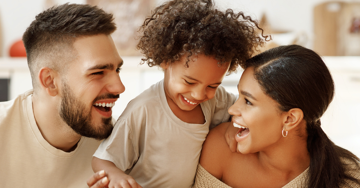 Parents laughing with a child