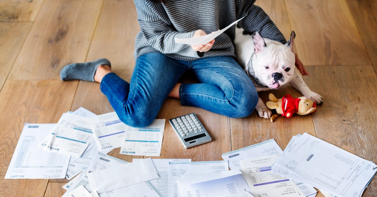 Woman with invoices, bills and her dog