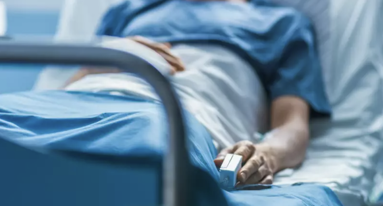 person lying in a hospital bed