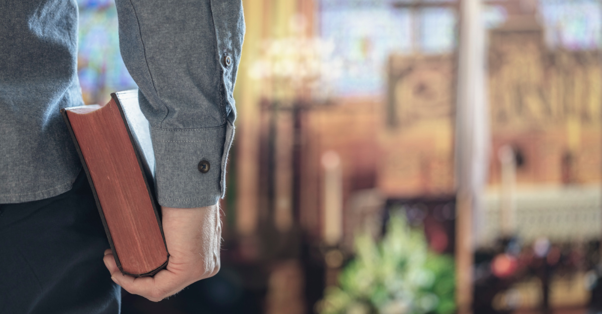 Man holding a Bible in a church