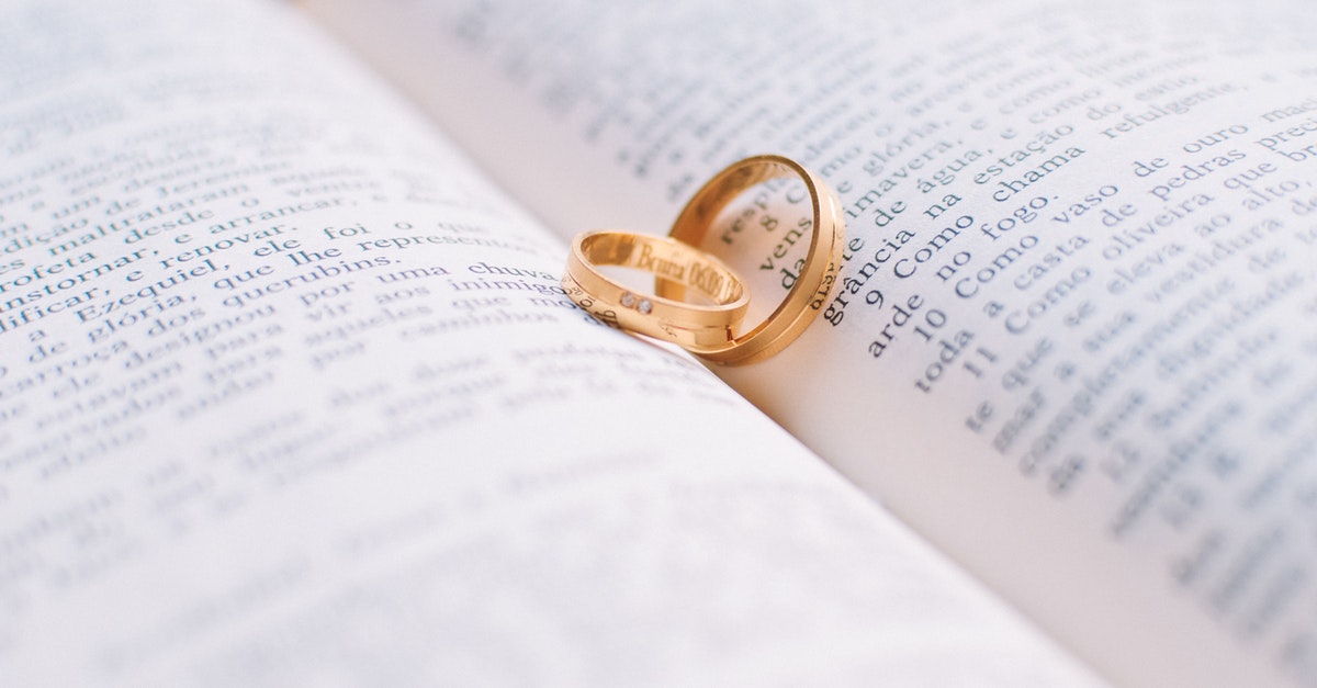 wedding rings resting on a Bible