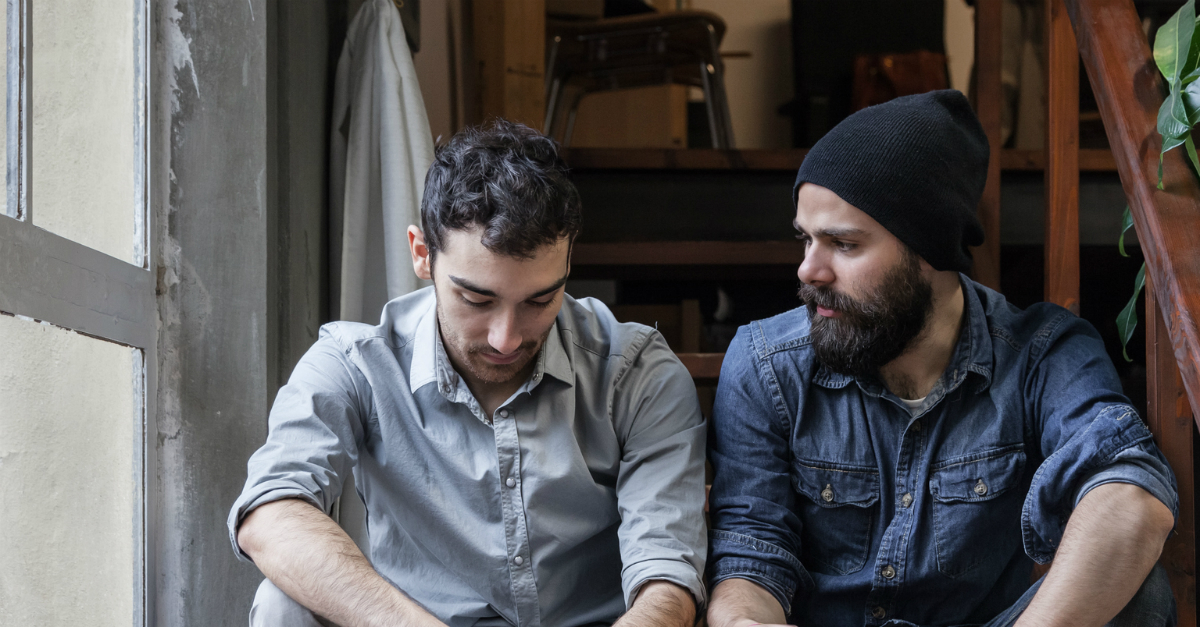 Two men, friends, having a serious conversation