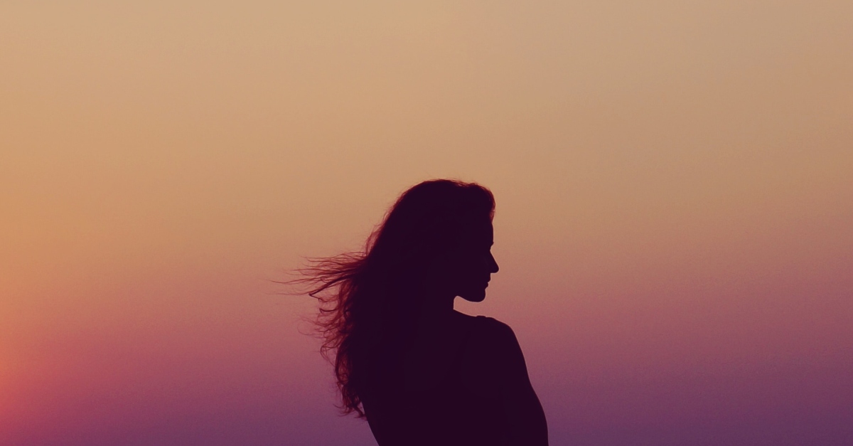 Silhouette of a woman at sunset