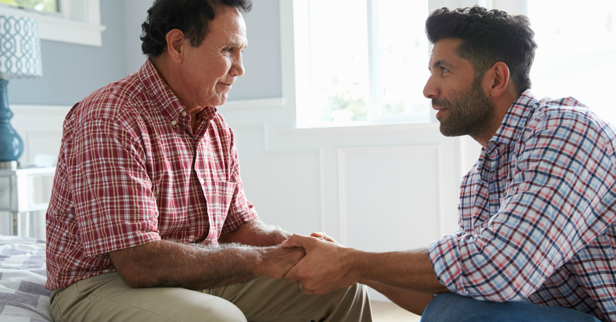 man talking to his elderly father