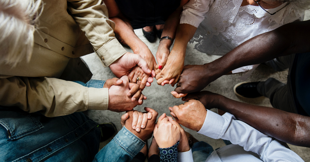 Group Holding Hands Praying