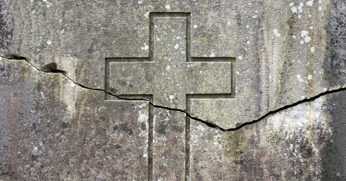 crack through cross etched on stone