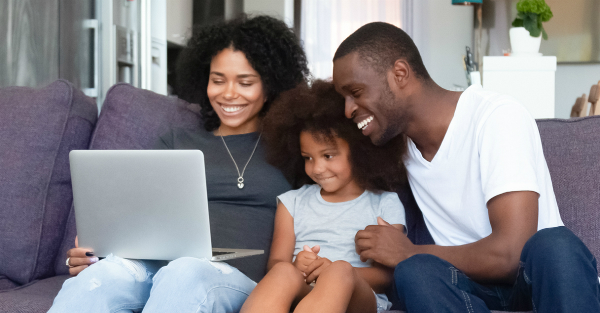 Happy family looking at a laptop