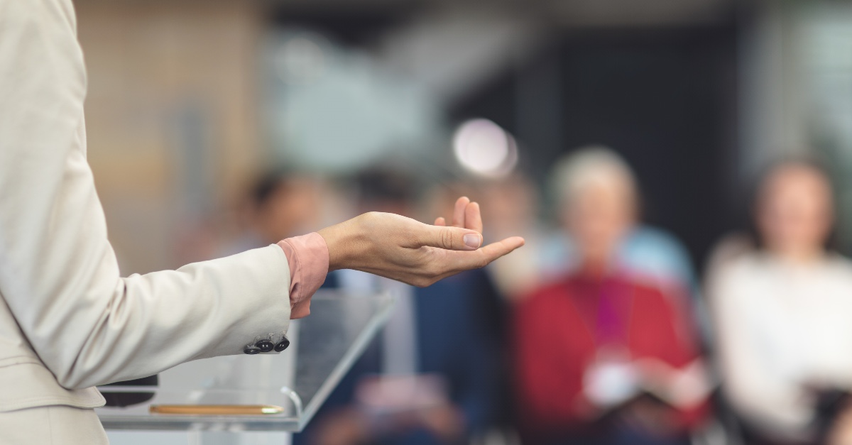 the hand of a person speaking, Julie Roys withdraws from conference over spiritual abuse claims