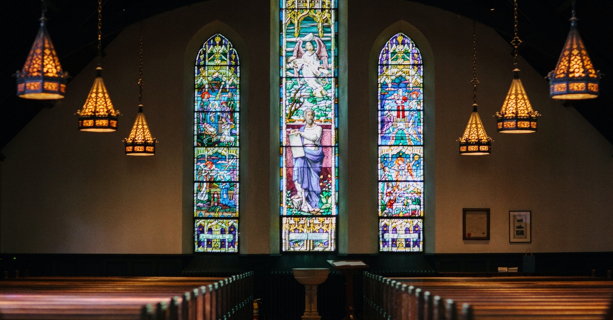 Church sanctuary with ornate stained glass windows