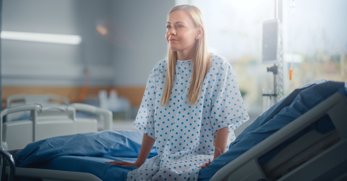 Woman sitting up in a hospital bed