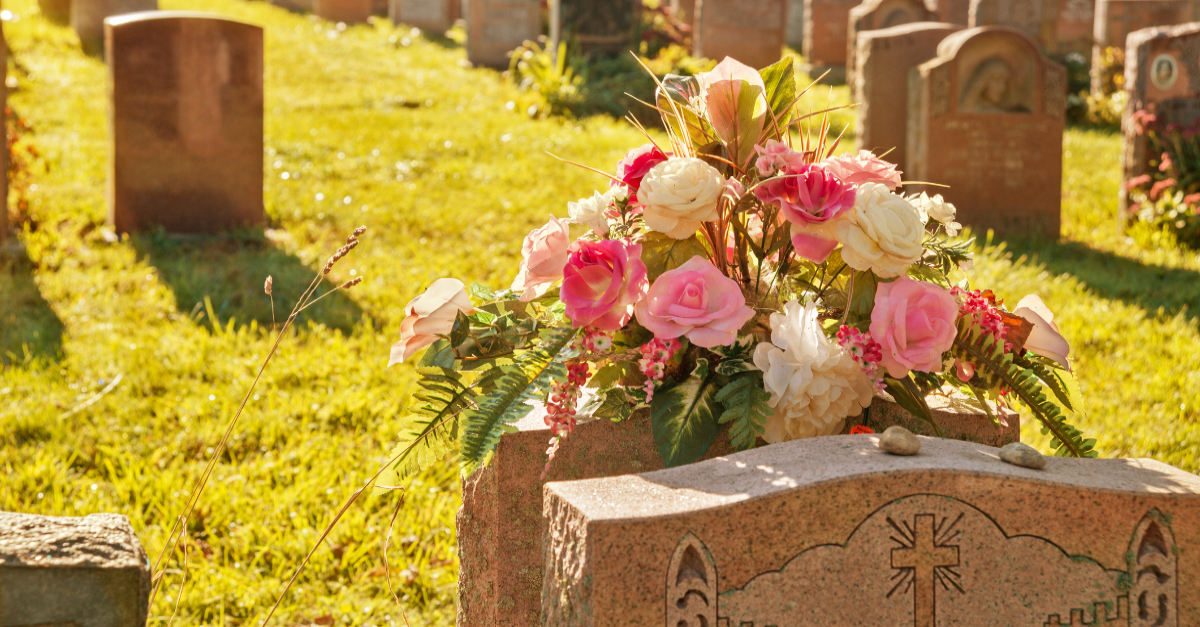 Flowers on a grave site, visiting a grave