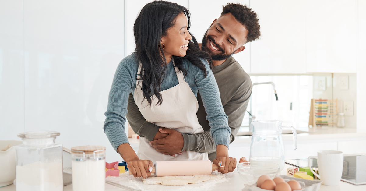 Couple baking together in kitchen