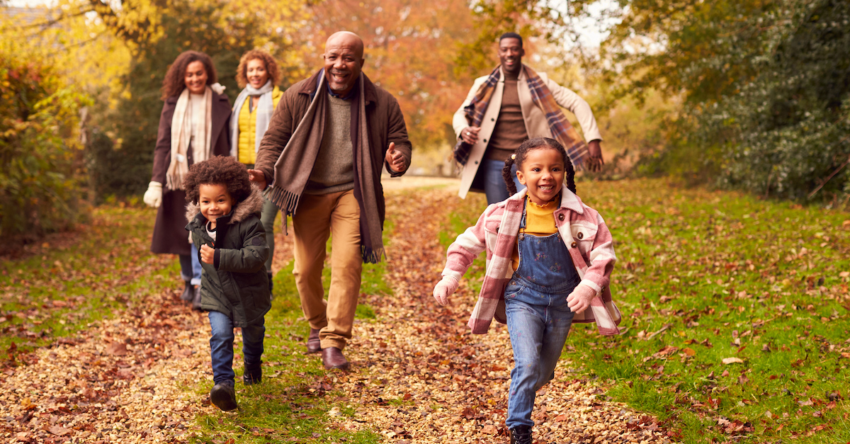 Family on autumn walk in leaves