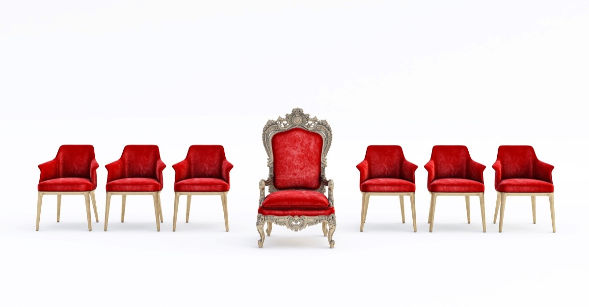 several red thrones lined up in white room