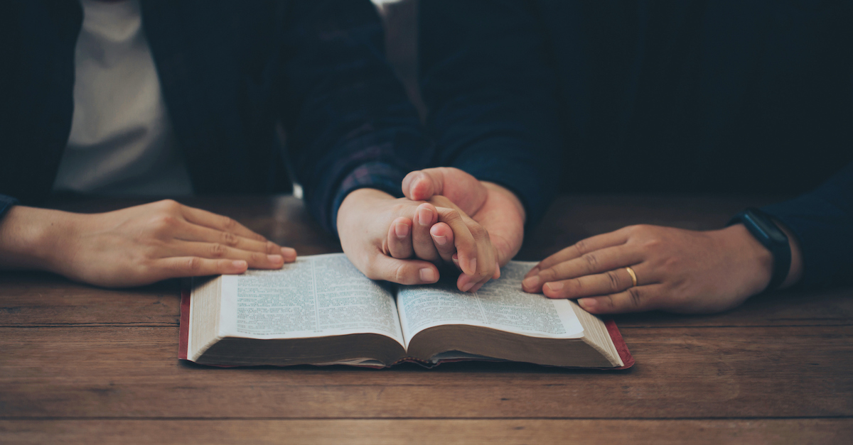 couple praying together about bible