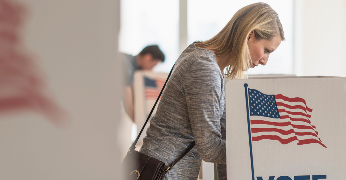 a woman voting at a voting booth