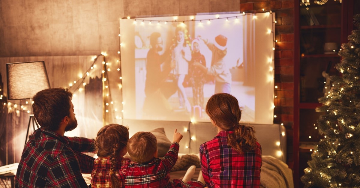 Family watching christmas movie on project, christmas movies netflix