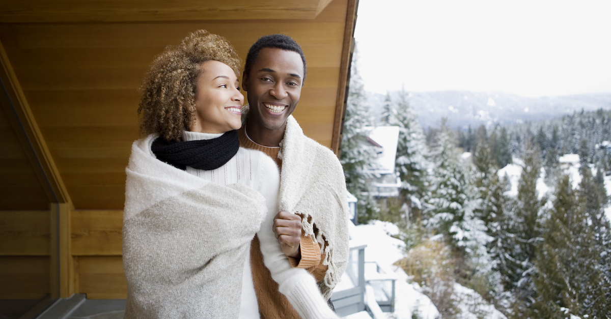 Happy cozy couple in snow for Christmas trip