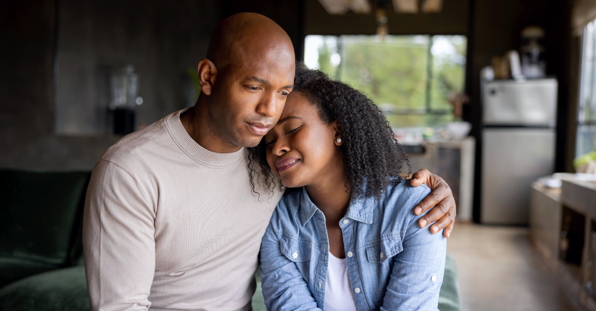 Man comforting a woman crying