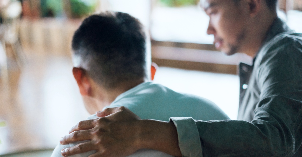 son comforting his father