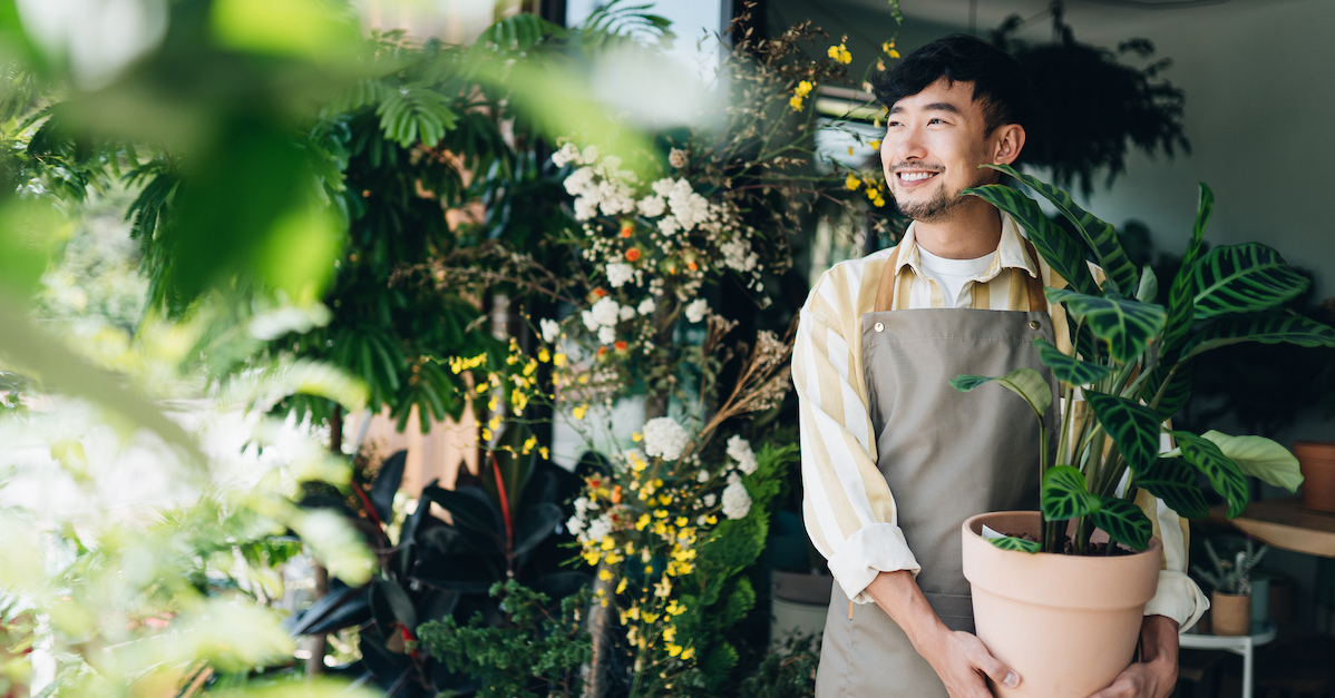 Man smiling at garden with plants gardener