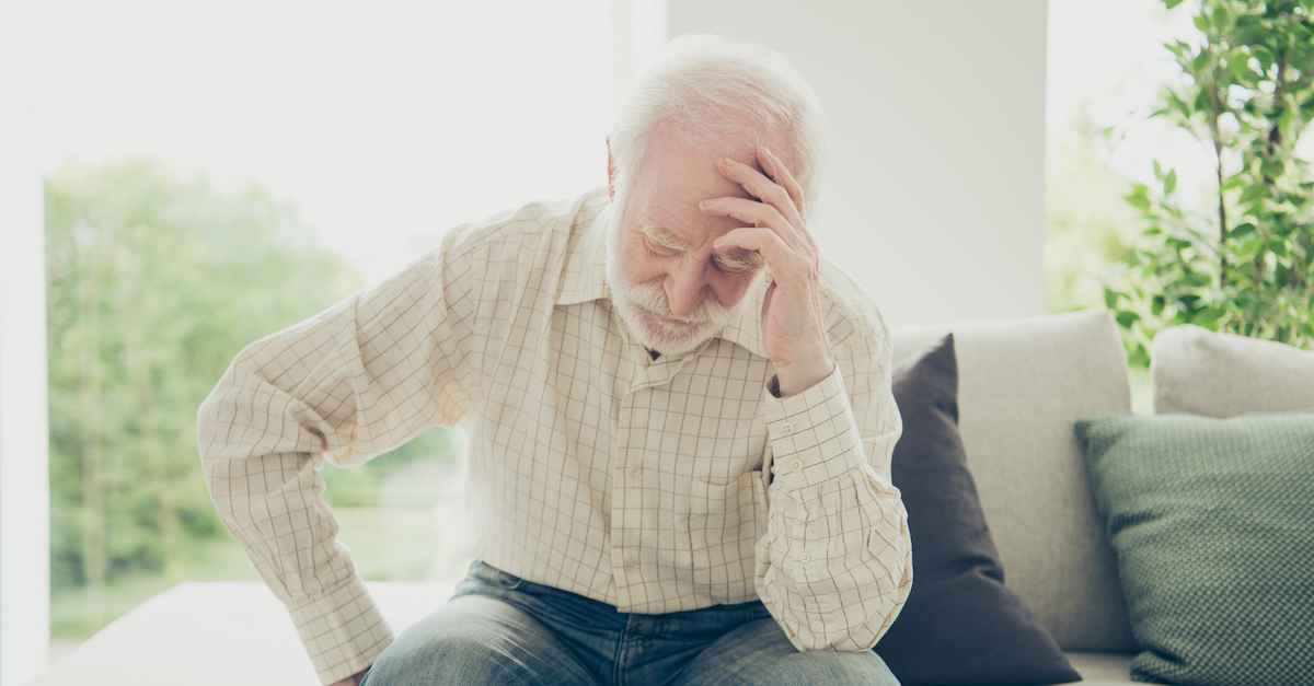 sad grandpa on couch thinking