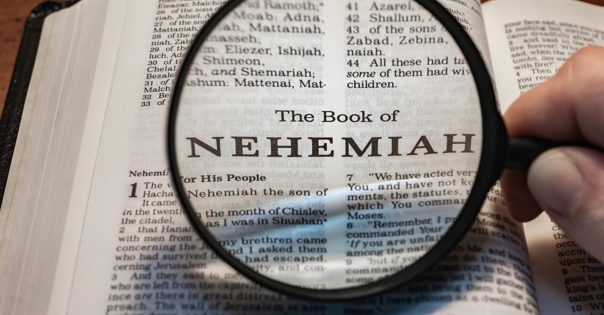 person holding magnifying glass up to book of nehemiah, nehemiahs prayer