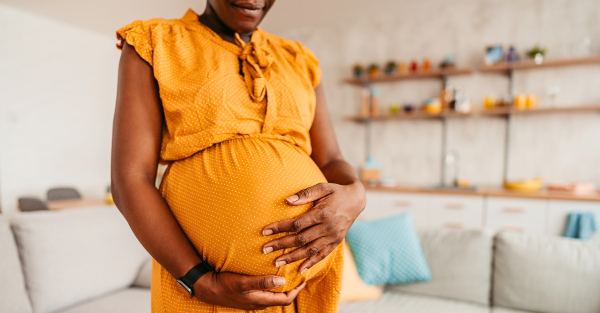 Woman rubbing her baby belly