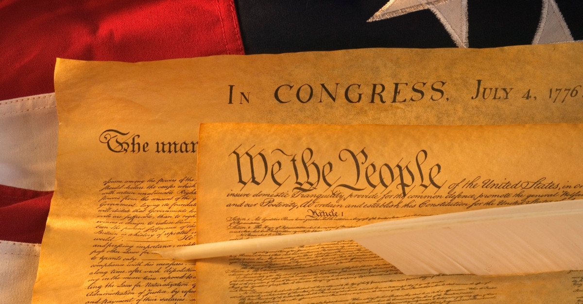 The Declaration of Independence over an American flag