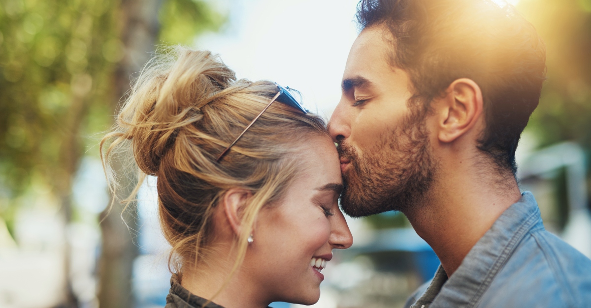 Husband kissing wifes head