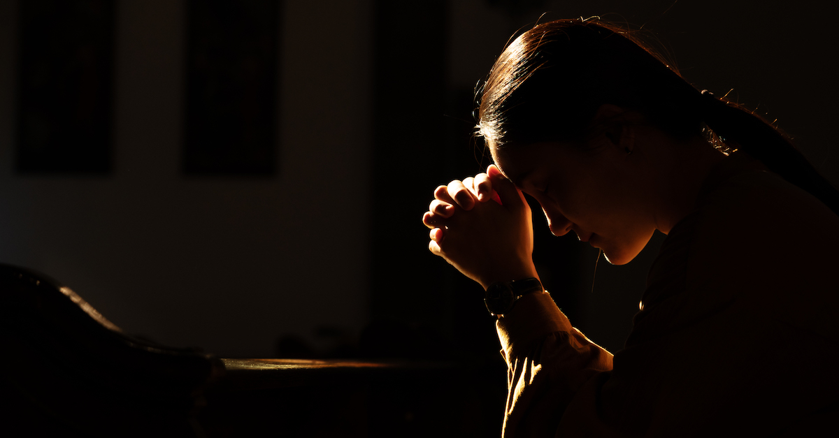 woman praying at night time