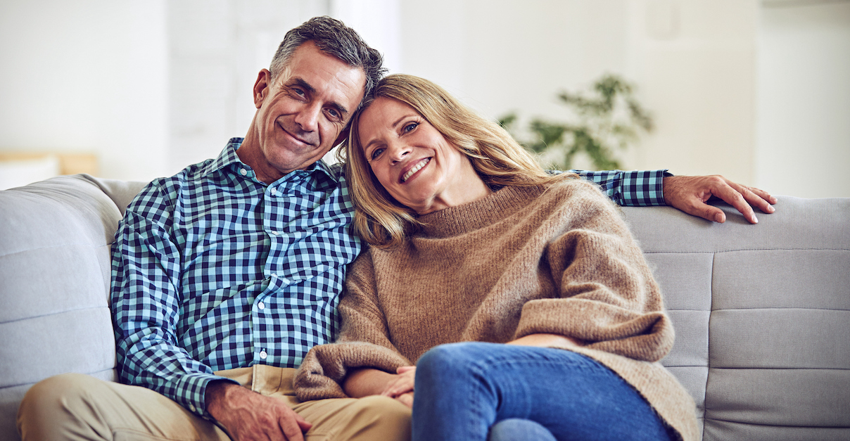 Happy older married couple on sofa