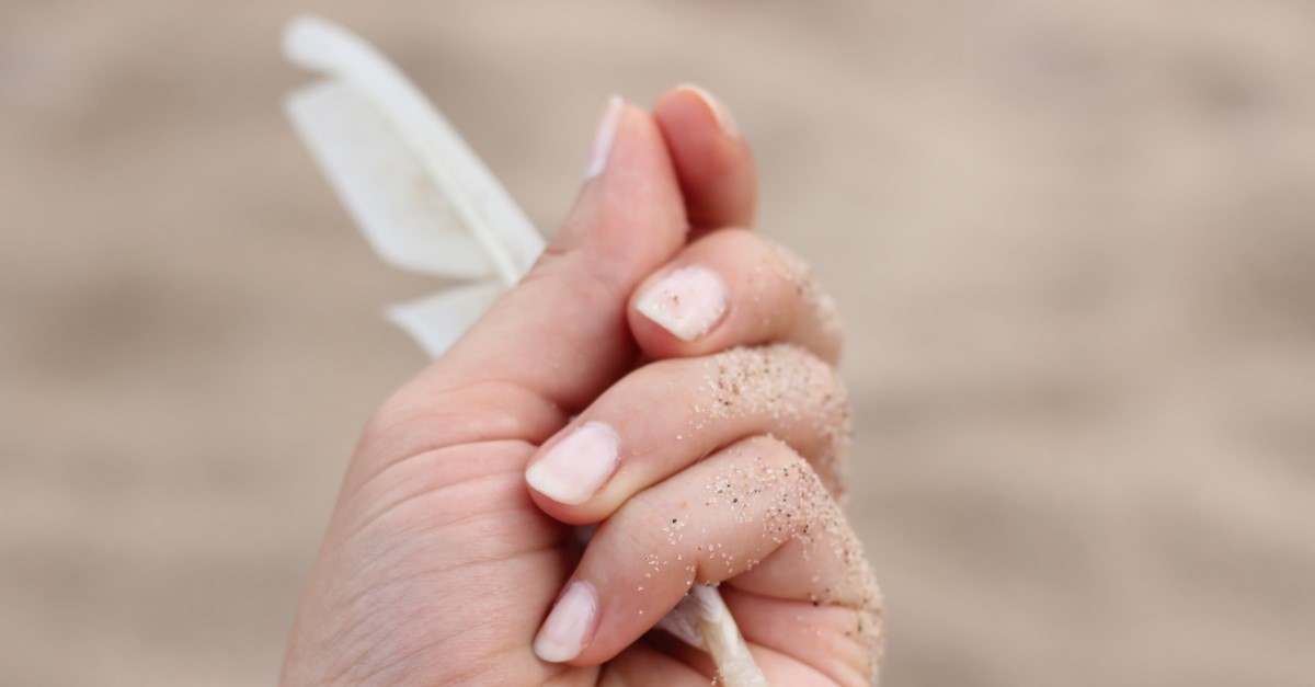 hand holding white feather, what does the bible say about masturbation