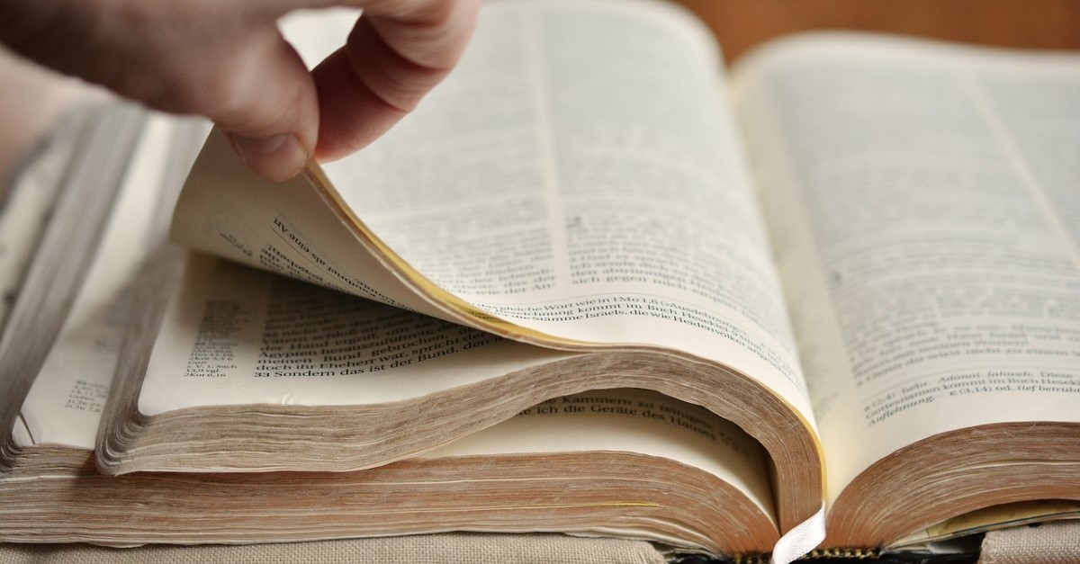 man flipping through bible pages, spiritual gift of discernment