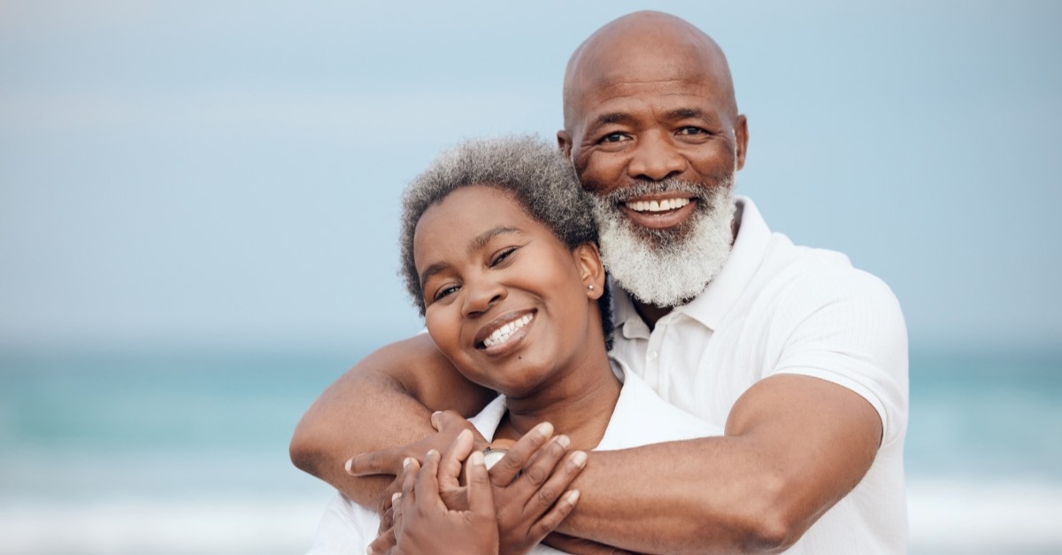 senior african-american couple smiling at beach