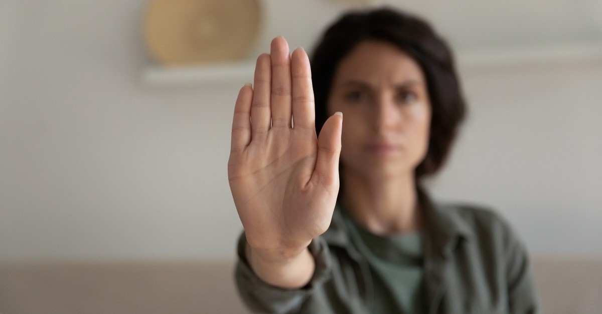 woman holding up hand to say stop