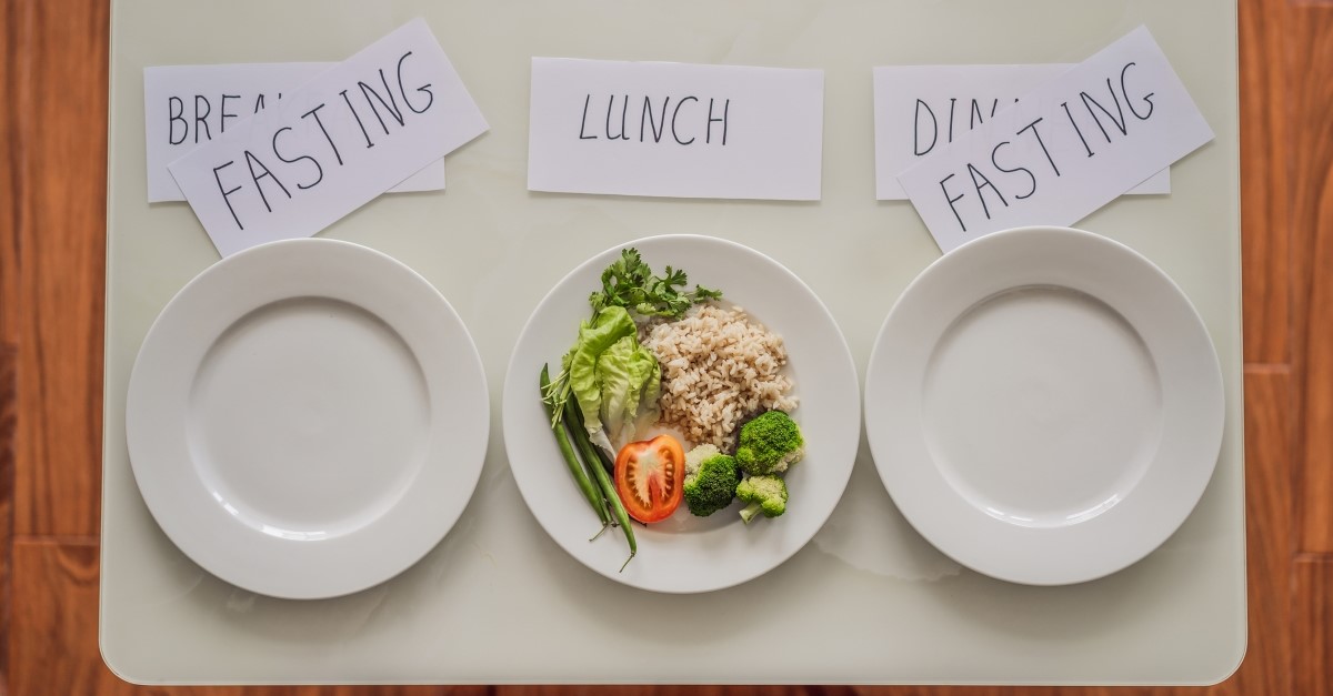 fasting illustration three plates only one with food on it