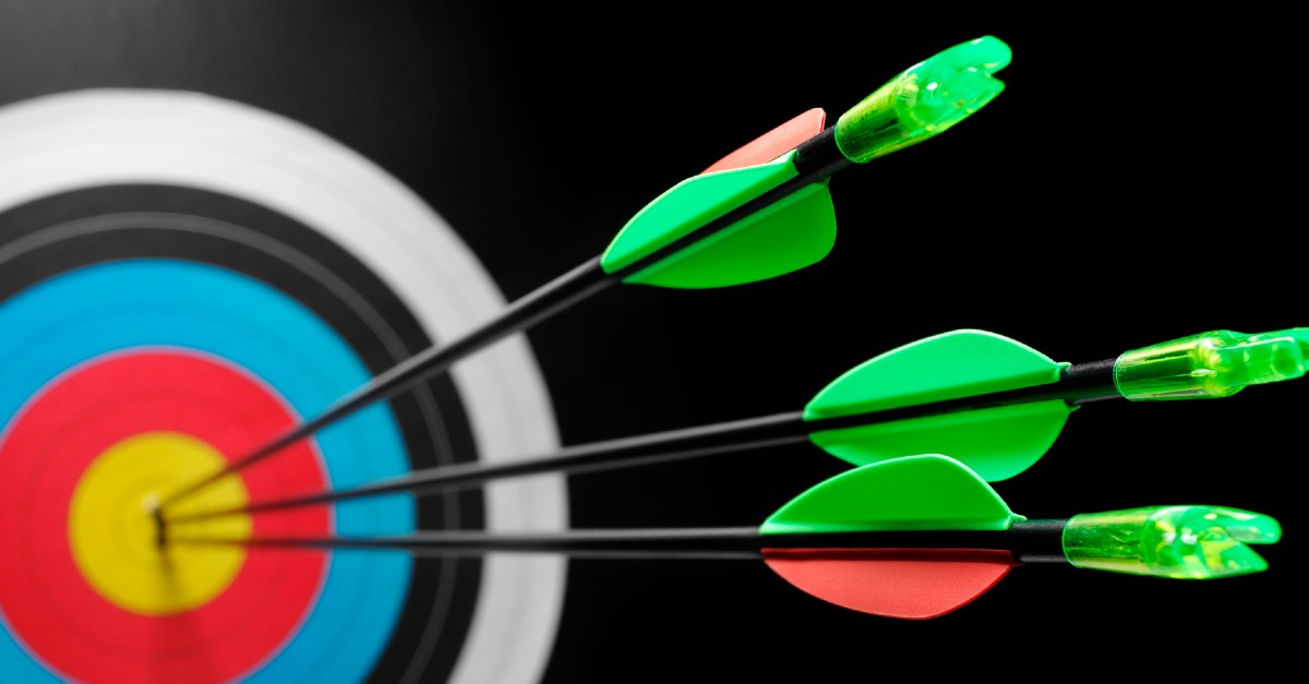 Three arrows in the bullseye on an archery target