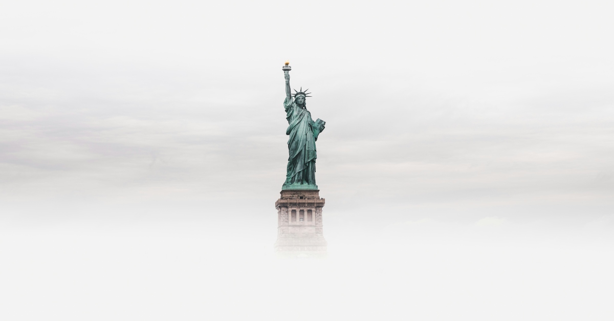 The statue of Liberty standing alone in the fog