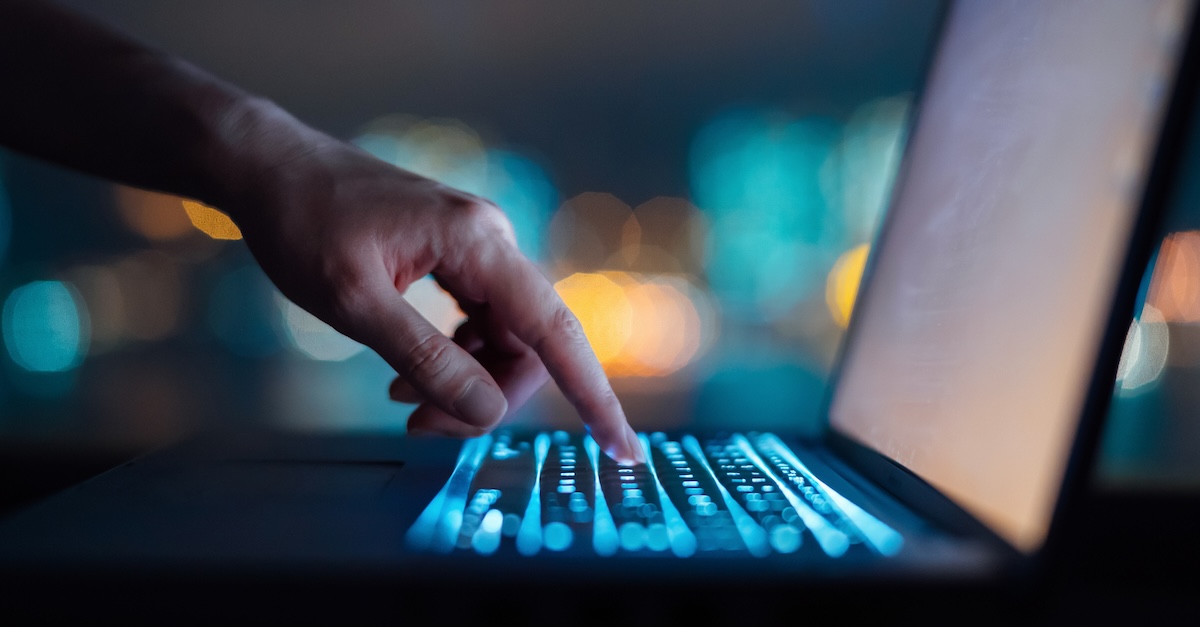 Typing on computer laptop posting social media