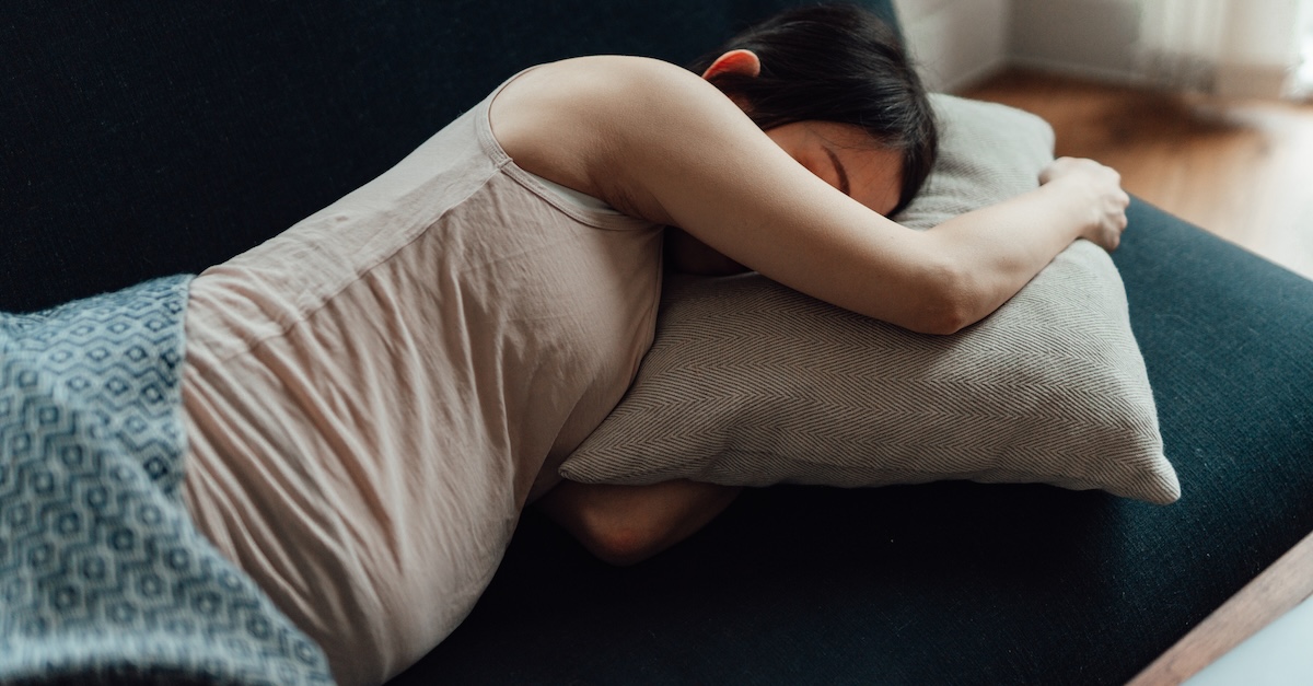 Tired sad depressed pregnant woman pregnancy on couch