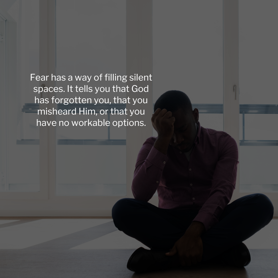 Man sitting on the floor in distress with a quote about fear and doubt