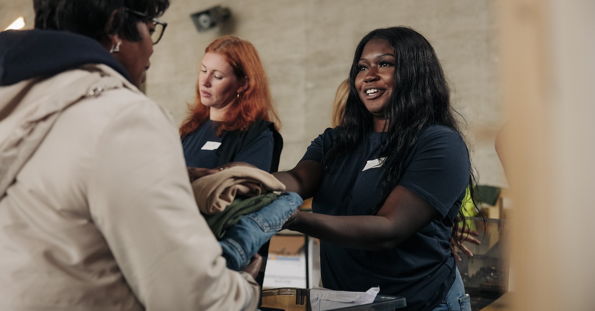 Women volunteering ministry handing out clothes service