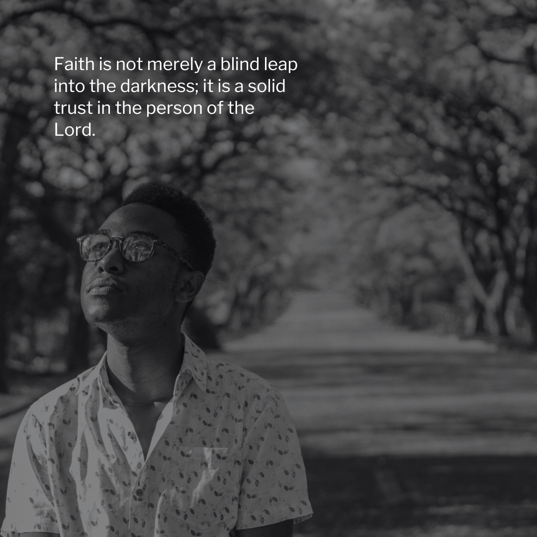 Black-and-white inspirational quote graphic showing a man wearing glasses standing on a tree-lined road and looking upward thoughtfully. White text reads, “Faith is not merely a blind leap into the darkness; it is a solid trust in the person of the Lord.”