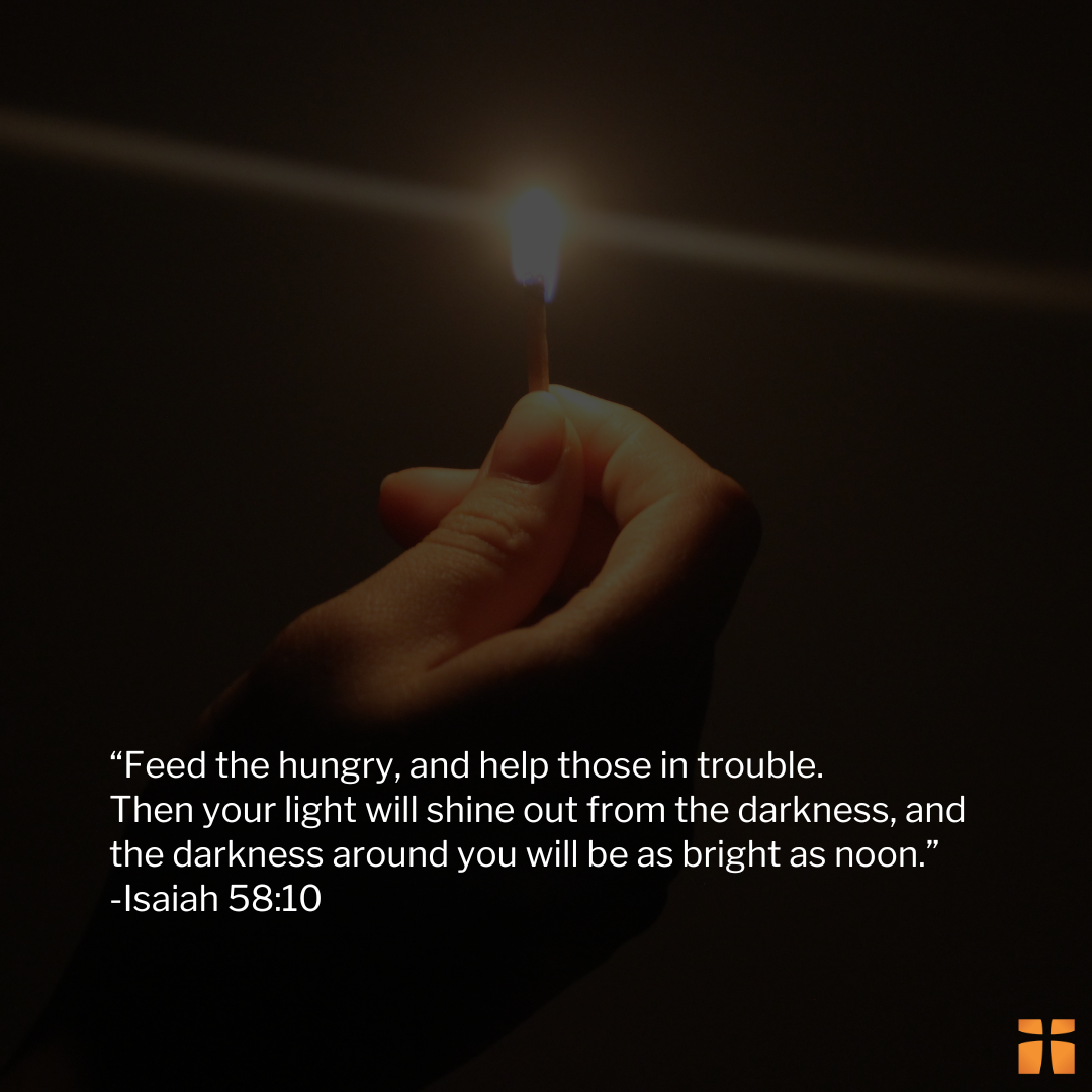Hand holding a lit match in the darkness beside a Bible verse about helping the hungry and bringing light to others.