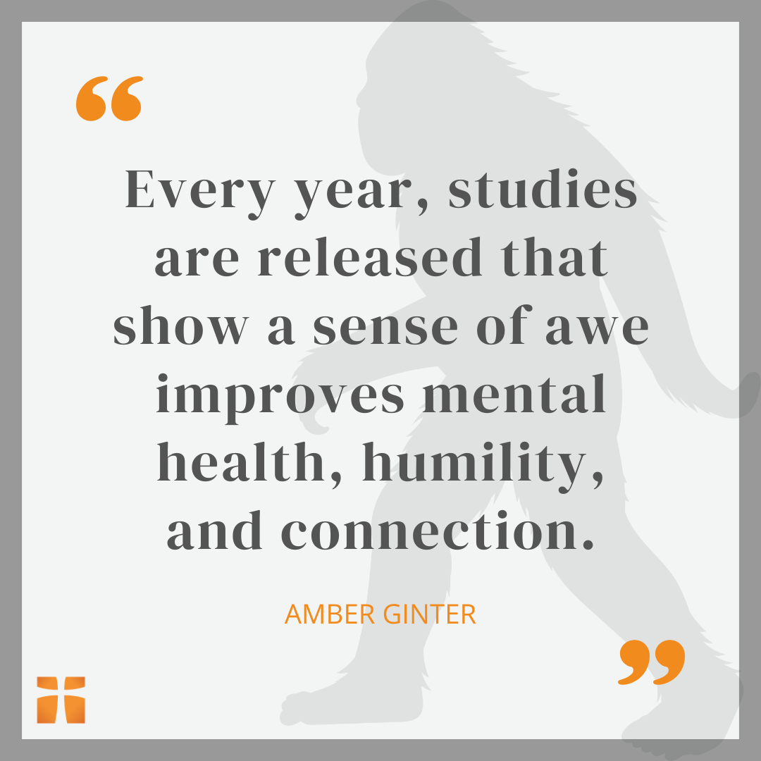 Quote graphic featuring a Bigfoot silhouette and the text: “Every year, studies are released that show a sense of awe improves mental health, humility, and connection.” — Amber Ginter.