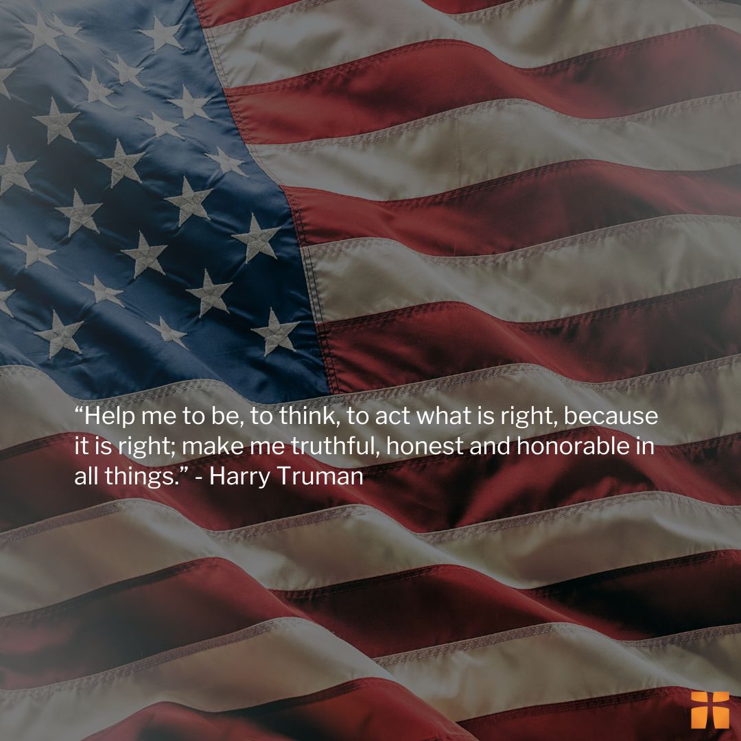 Close-up of a waving American flag featuring a quote from Harry Truman about acting rightly, truthfulness, honesty, and honor.