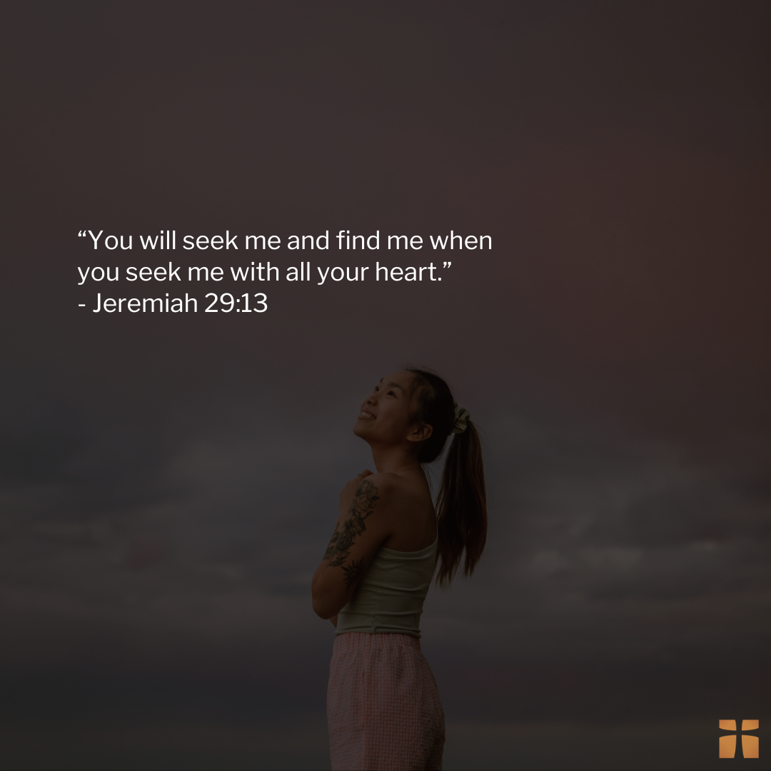 Quote graphic featuring Jeremiah 29:13, “You will seek me and find me when you seek me with all your heart,” displayed over a darkened image of a woman standing outdoors and looking upward toward the sky in reflection and hope.